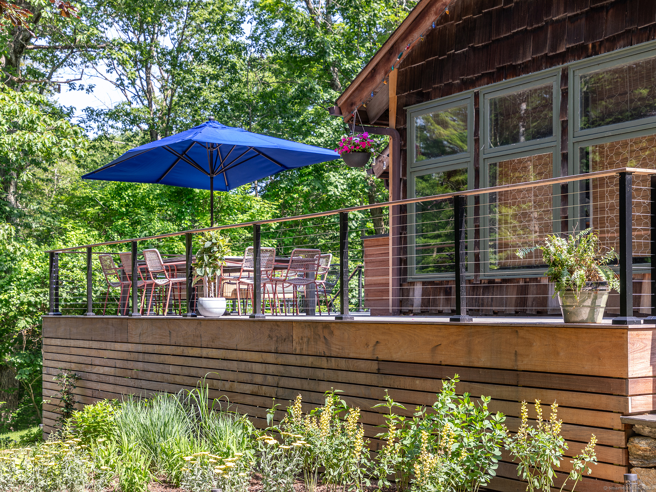 203 Brick School Road Warren, CT 06754 - Photo 3 of 40 a view of a deck with a table and chairs under an umbrella