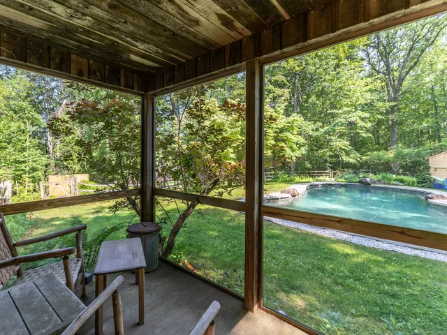 a backyard of a house with yard table and chairs