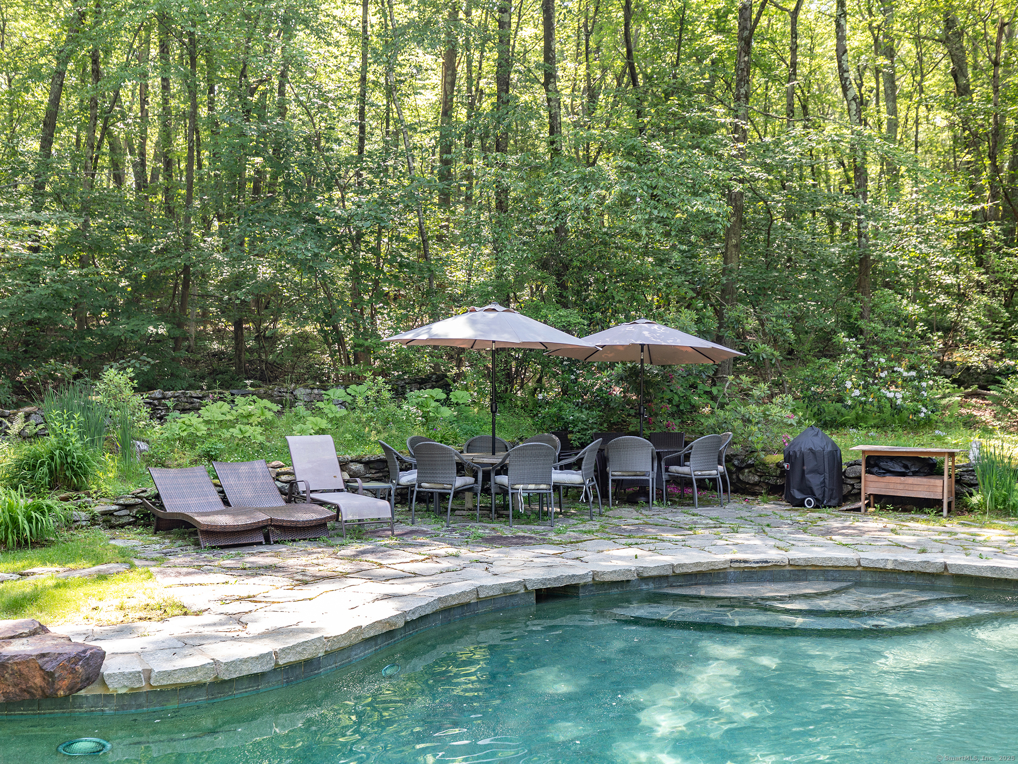 203 Brick School Road Warren, CT 06754 - Photo 37 of 40 a backyard of a house with yard table and chairs