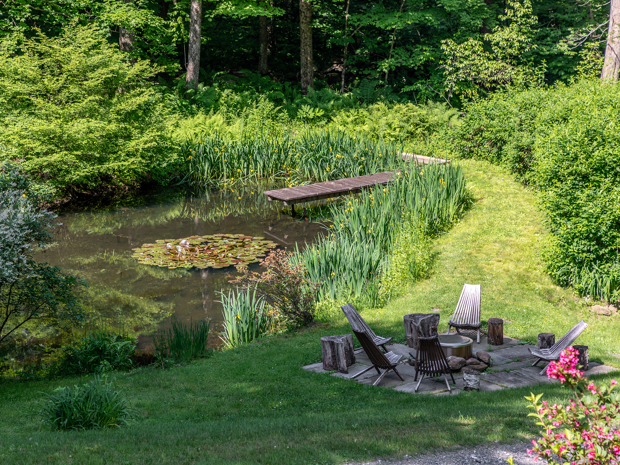 203 Brick School Road Warren, CT 06754 - Photo 9 of 40 a view of a table and chairs in the garden