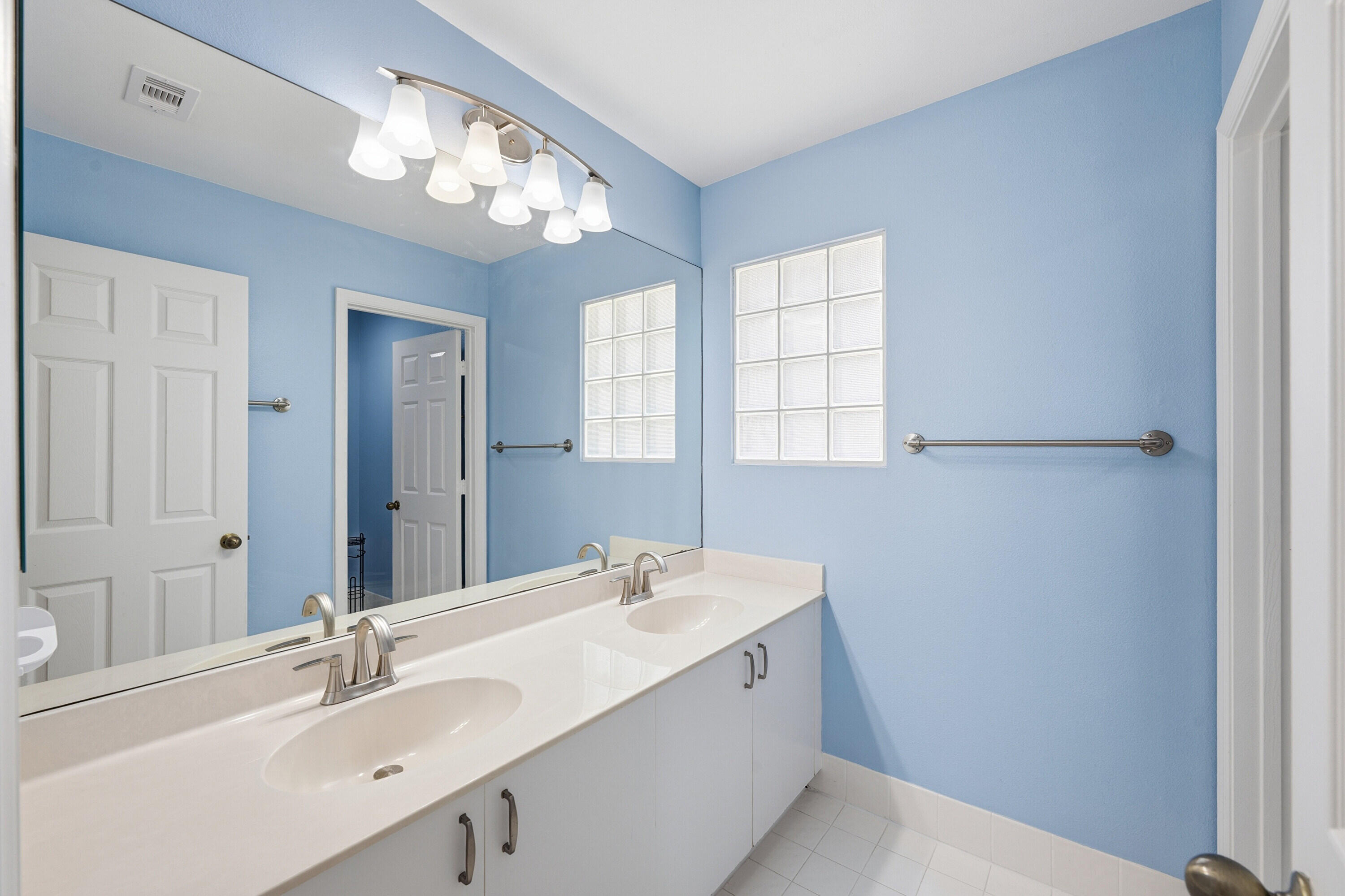 18474 Old Princeton Lane Boca Raton, FL 33498 - Photo 34 of 46 a bathroom with a sink a large mirror and a bathtub