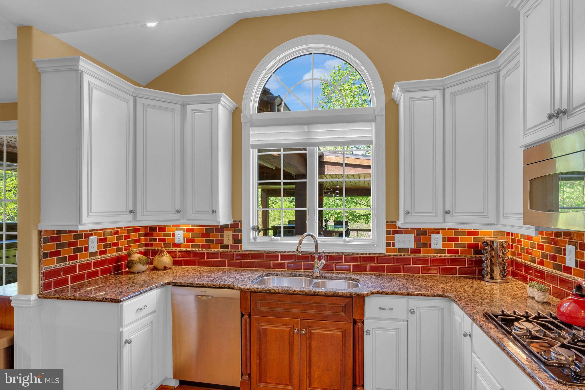 115 Muirfield Lane Chalfont, PA 18914 - Photo 19 of 59 a kitchen with stainless steel appliances granite countertop a sink a stove and a wooden cabinets