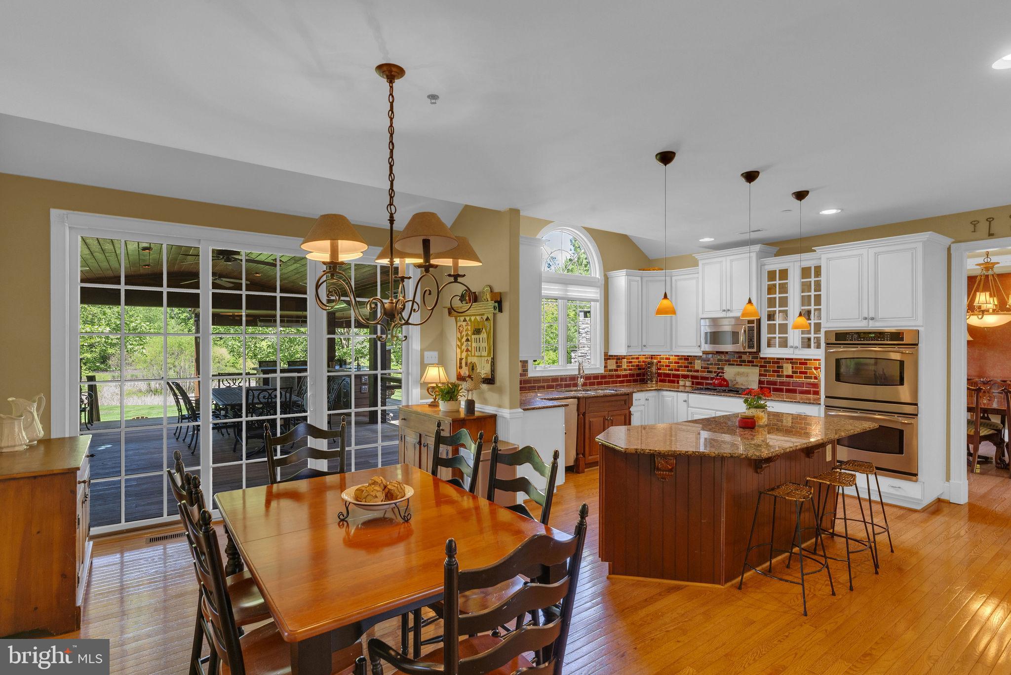 115 Muirfield Lane Chalfont, PA 18914 - Photo 20 of 59 a dining room with furniture a chandelier and wooden floor