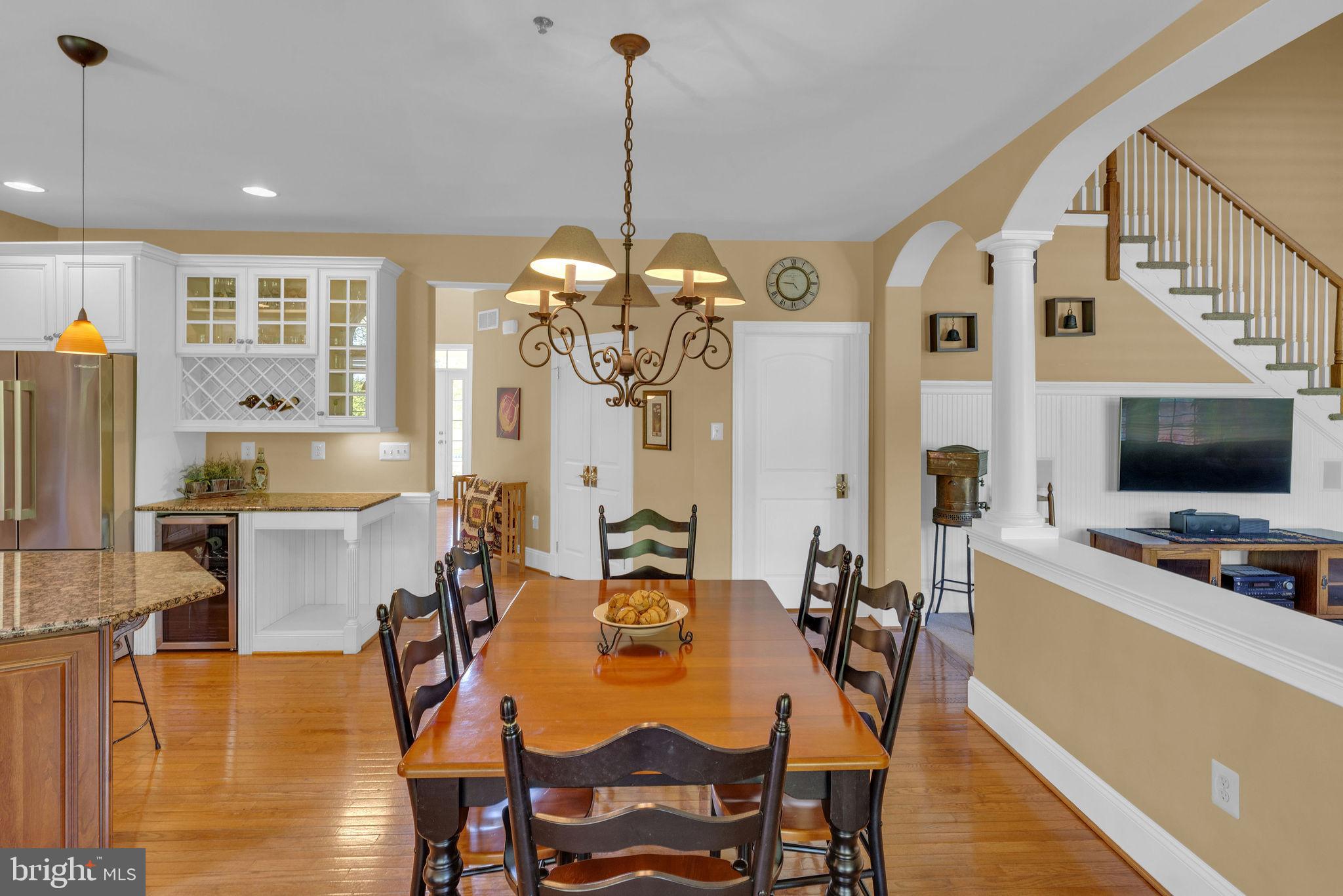 115 Muirfield Lane Chalfont, PA 18914 - Photo 21 of 59 a view of a dining room and livingroom with furniture wooden floor a chandelier