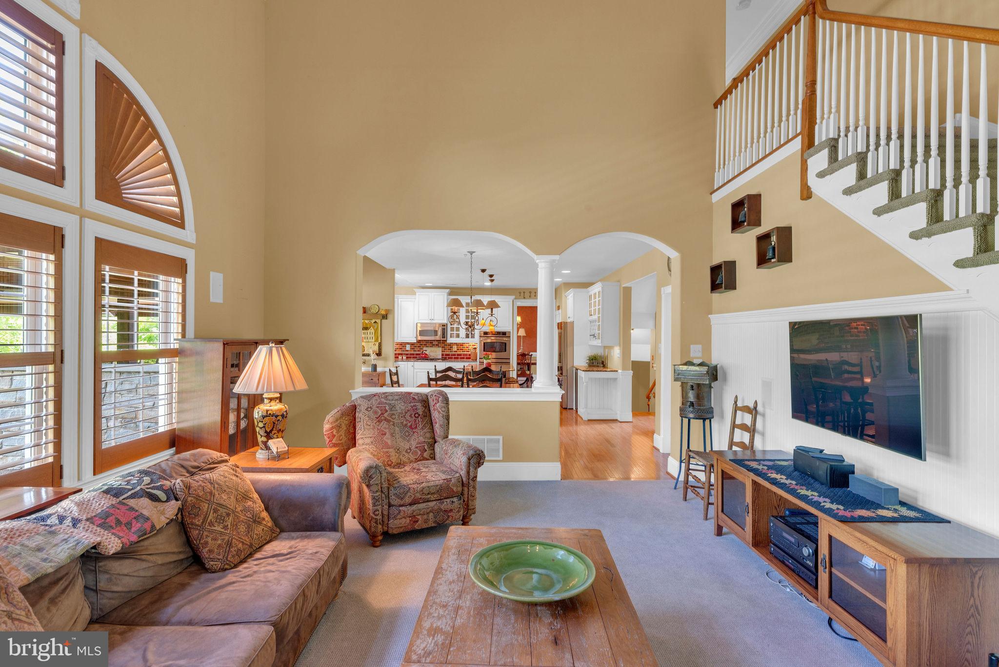 115 Muirfield Lane Chalfont, PA 18914 - Photo 26 of 59 a living room with furniture a flat screen tv and a floor to ceiling window