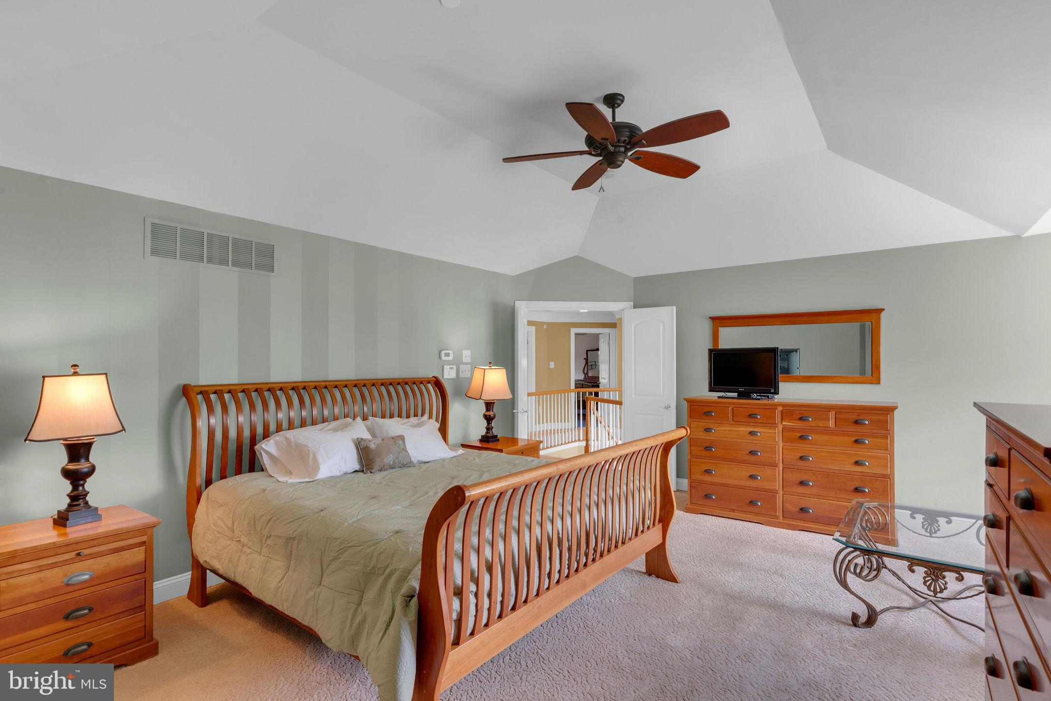 115 Muirfield Lane Chalfont, PA 18914 - Photo 29 of 59 a bedroom with a bed and a chandelier