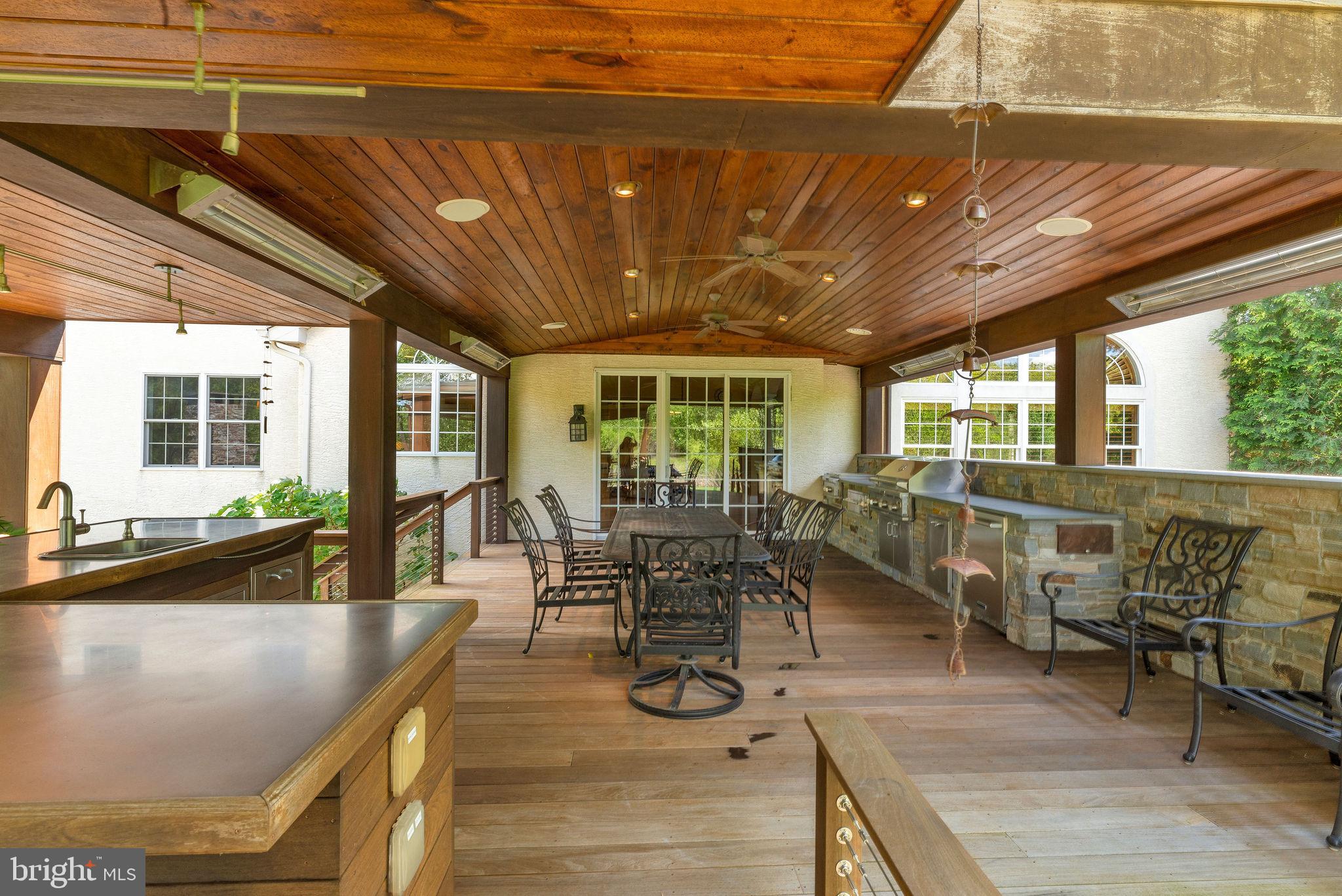 115 Muirfield Lane Chalfont, PA 18914 - Photo 5 of 59 a dining hall with couches a dining table and chairs with outer view