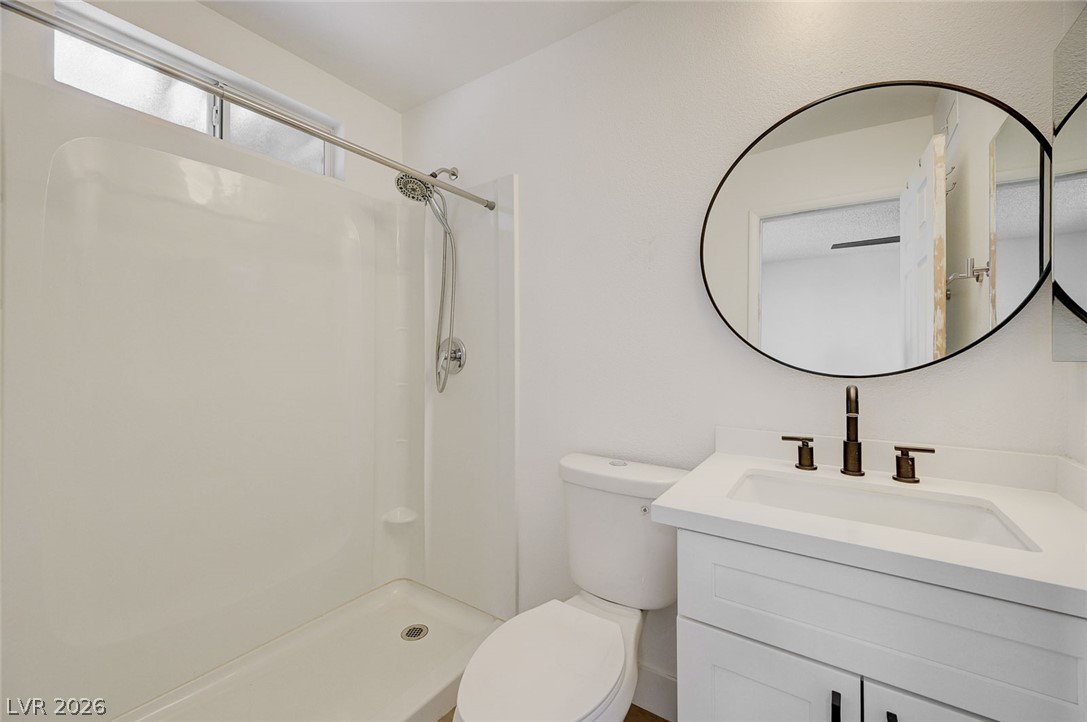4840 Summerhill Road Las Vegas, NV 89121 - Photo 30 of 56 A well-appointed bathroom with a modern vanity and bright, clean shower.
