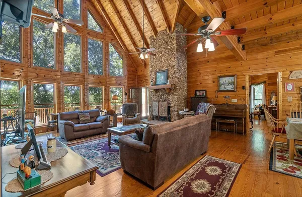 a living room with fireplace furniture and a flat screen tv