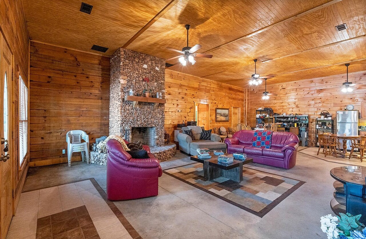 2221 County Road 6 Wedowee, AL 36278 - Photo 31 of 40 a living room with patio furniture and a fireplace