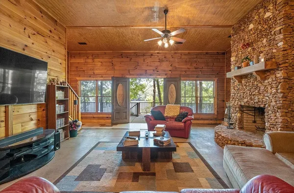 a dining room with stainless steel appliances kitchen island granite countertop a table chairs and a refrigerator