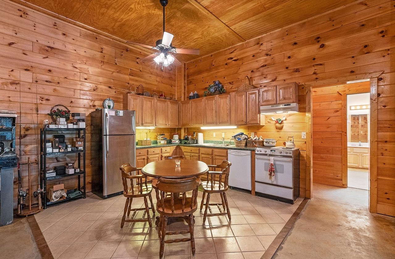 2221 County Road 6 Wedowee, AL 36278 - Photo 35 of 40 a dining room with stainless steel appliances kitchen island granite countertop a table chairs and a refrigerator