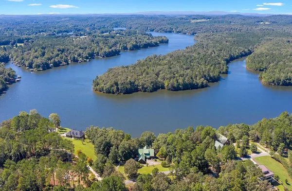 an aerial view of a house with a lake view