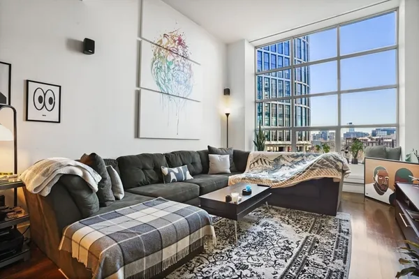 a living room with furniture and a floor to ceiling window