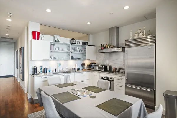 a kitchen with stainless steel appliances granite countertop a refrigerator sink and stove