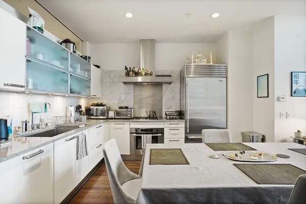 a kitchen with stainless steel appliances kitchen island granite countertop a sink stove and cabinets