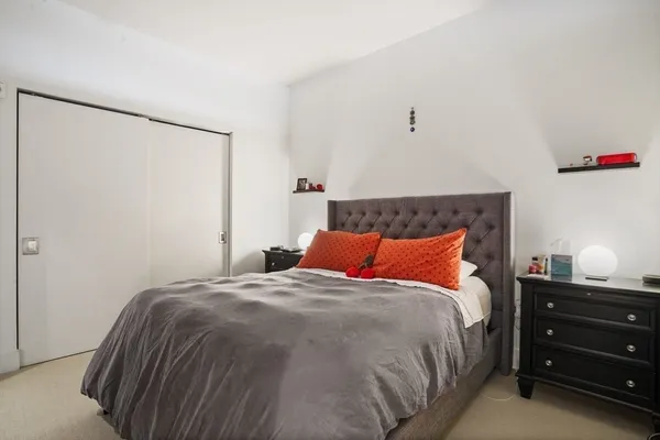 a bedroom with a bed and a dresser