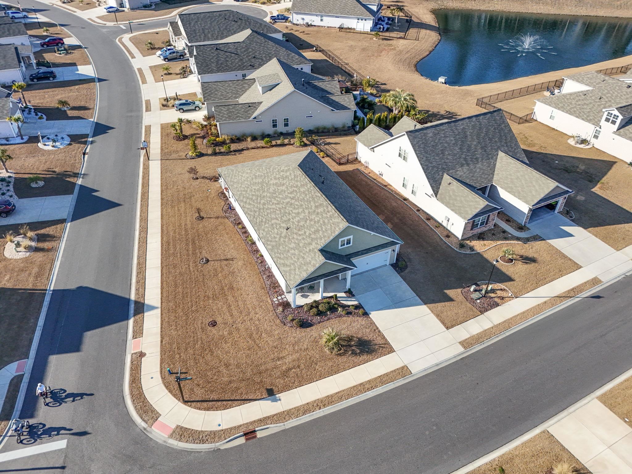 3111 Sutherland Drive Little River, SC 29566 - Photo 13 of 16 Aerial perspective of suburban area with a nearby body of water