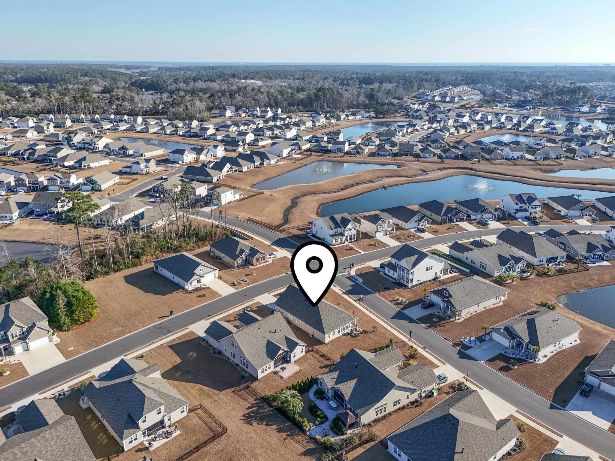 3111 Sutherland Drive Little River, SC 29566 - Photo 15 of 16 Aerial view of property's location with nearby suburban area and a nearby body of water