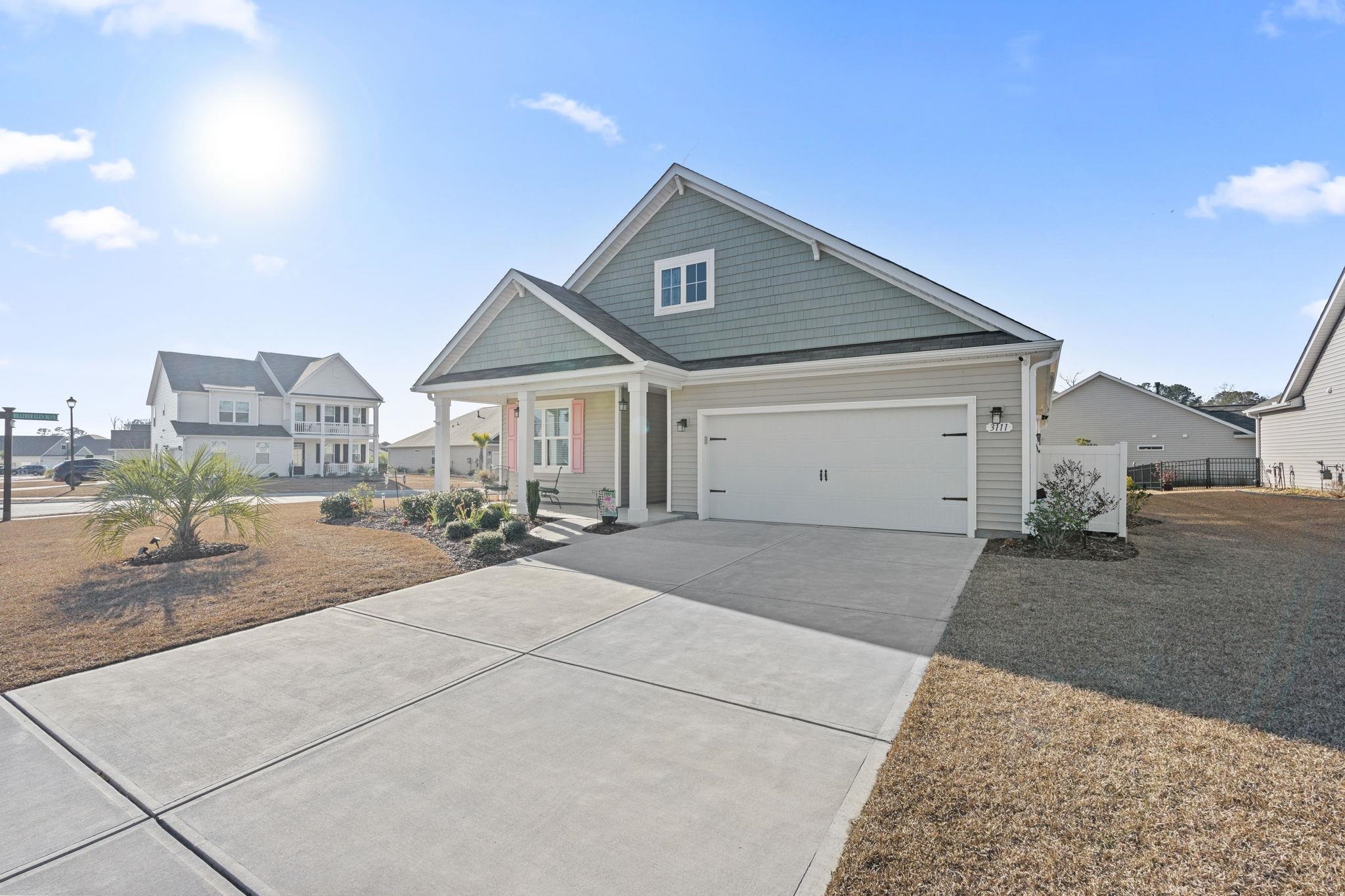 3111 Sutherland Drive Little River, SC 29566 - Photo 4 of 16 Craftsman-style house featuring a garage, driveway, and a porch
