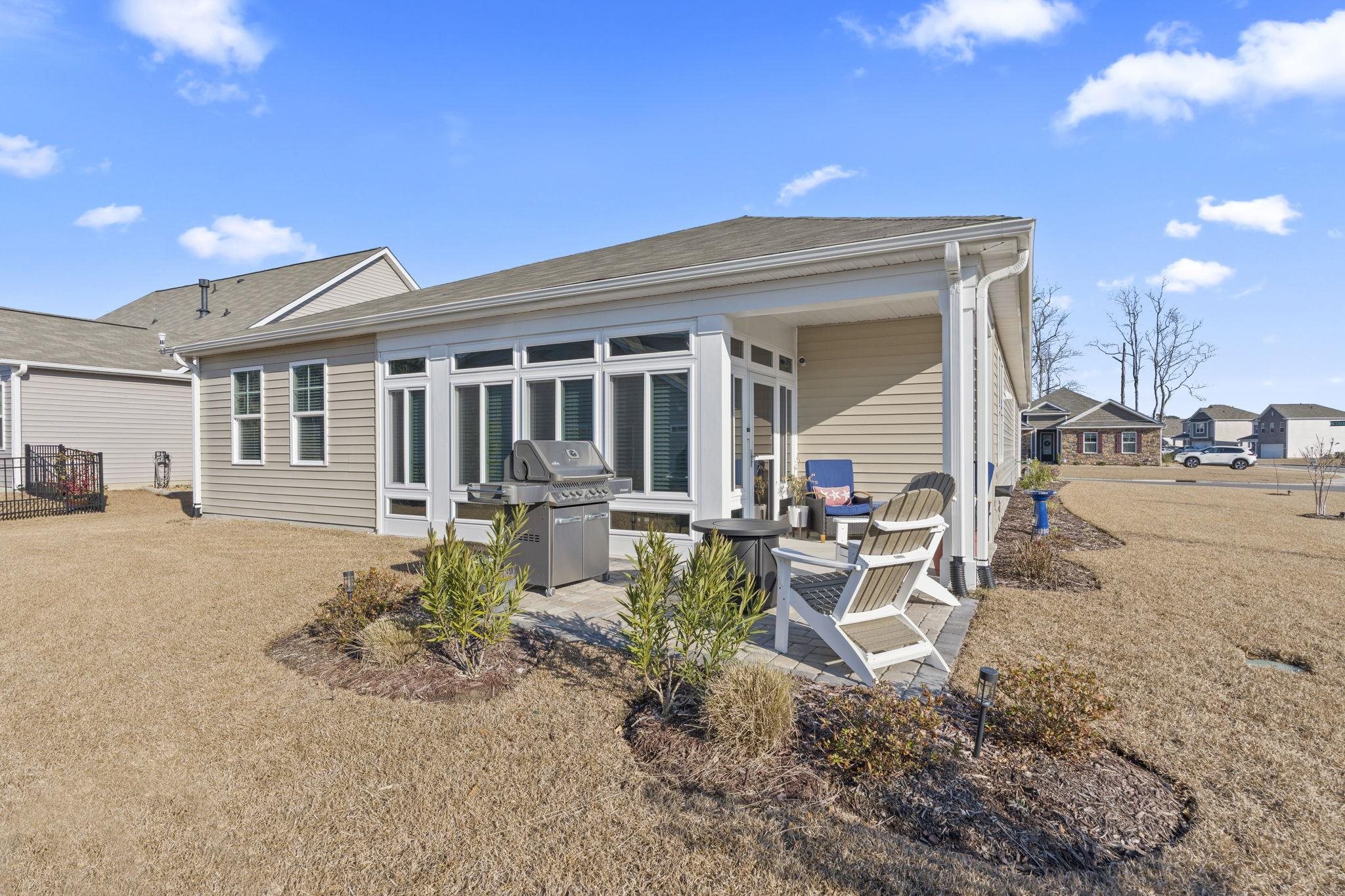 3111 Sutherland Drive Little River, SC 29566 - Photo 9 of 16 Rear view of property featuring a patio area, a lawn, and roof with shingles
