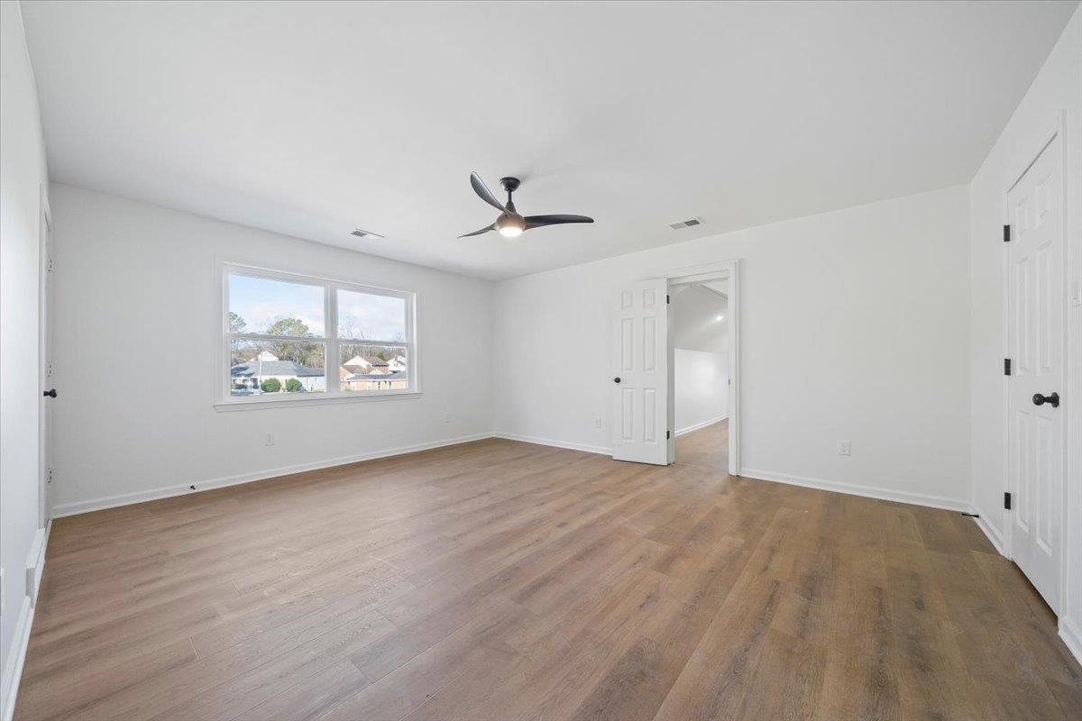 1676 Miller Farms Road Germantown, TN 38138 - Photo 24 of 37 Spacious interior room featuring wood-finish flooring, white walls, and a contemporary black ceiling fan