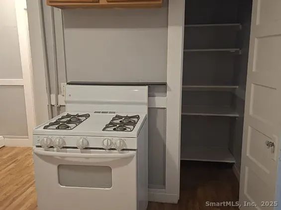 a stove top oven sitting inside of a kitchen