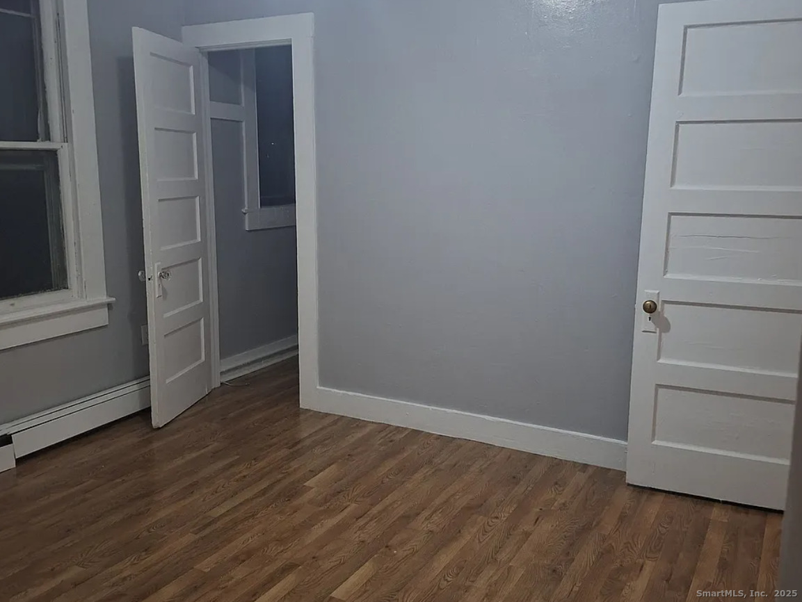 1403 Corbin Avenue New Britain, CT 06053 - Photo 6 of 6 a view of an empty room with wooden floor and closet