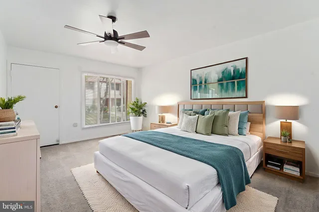 a spacious bedroom with a bed and a chandelier