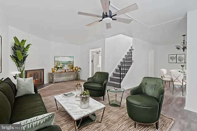 a living room with furniture and a potted plant