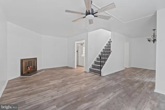 a view of an empty room with a window and staircase