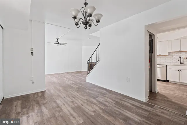 a view of a room with wooden floor and staircase
