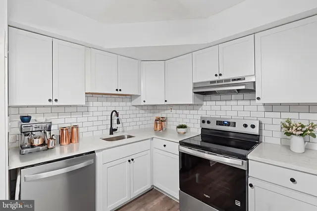 a kitchen with cabinets appliances a sink and a cabinets