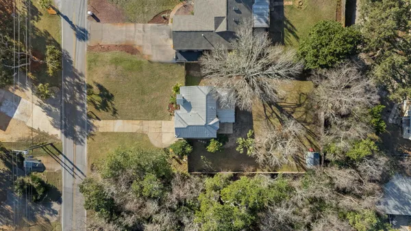 an aerial view of a house with a yard