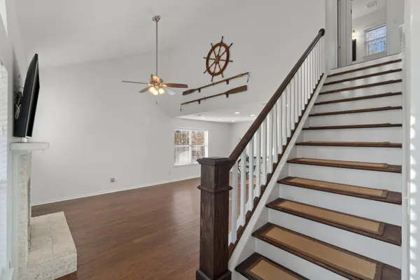 a view of entryway and hall with wooden floor