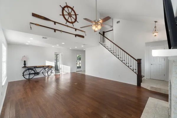 a view of a room with wooden floor chandelier and entryway