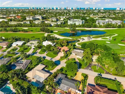 an aerial view of residential houses with outdoor space and parking