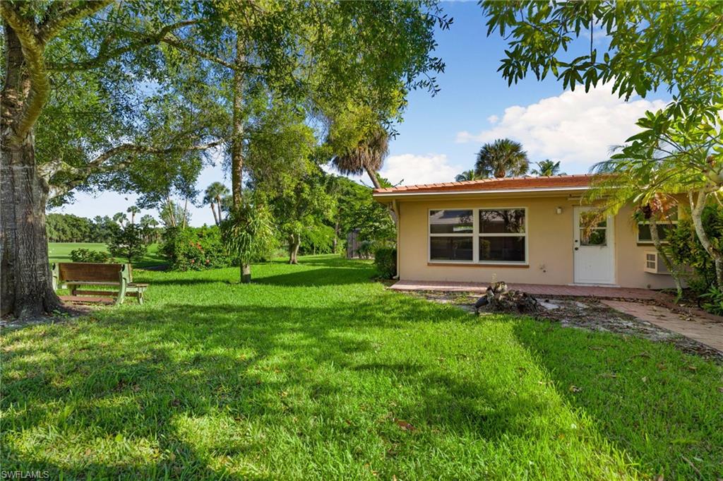 77 Cypress Point Drive Naples, FL 34105 - Photo 23 of 23 a view of a house with a yard