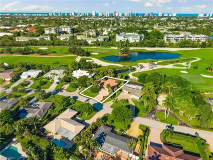 an aerial view of residential houses with outdoor space and street view