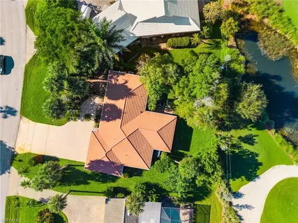 an aerial view of a house with swimming pool and garden