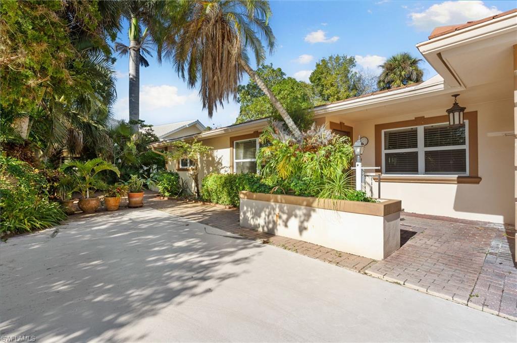 77 Cypress Point Drive Naples, FL 34105 - Photo 10 of 23 a view of a house with a patio