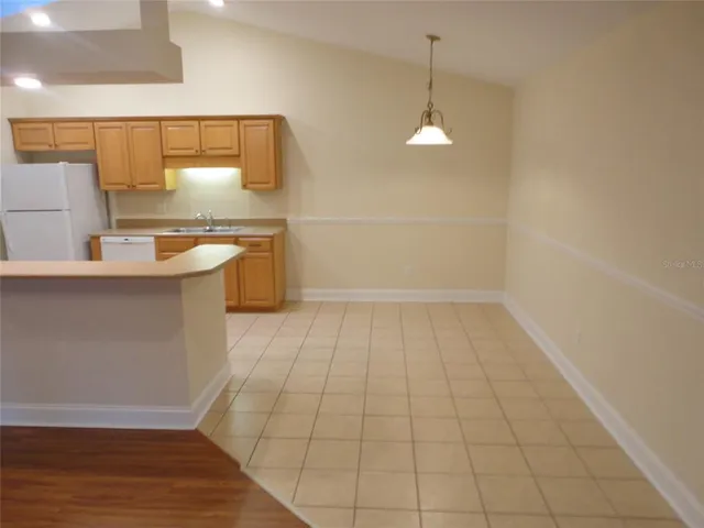 a view of a kitchen with a sink stainless steel appliances and cabinets