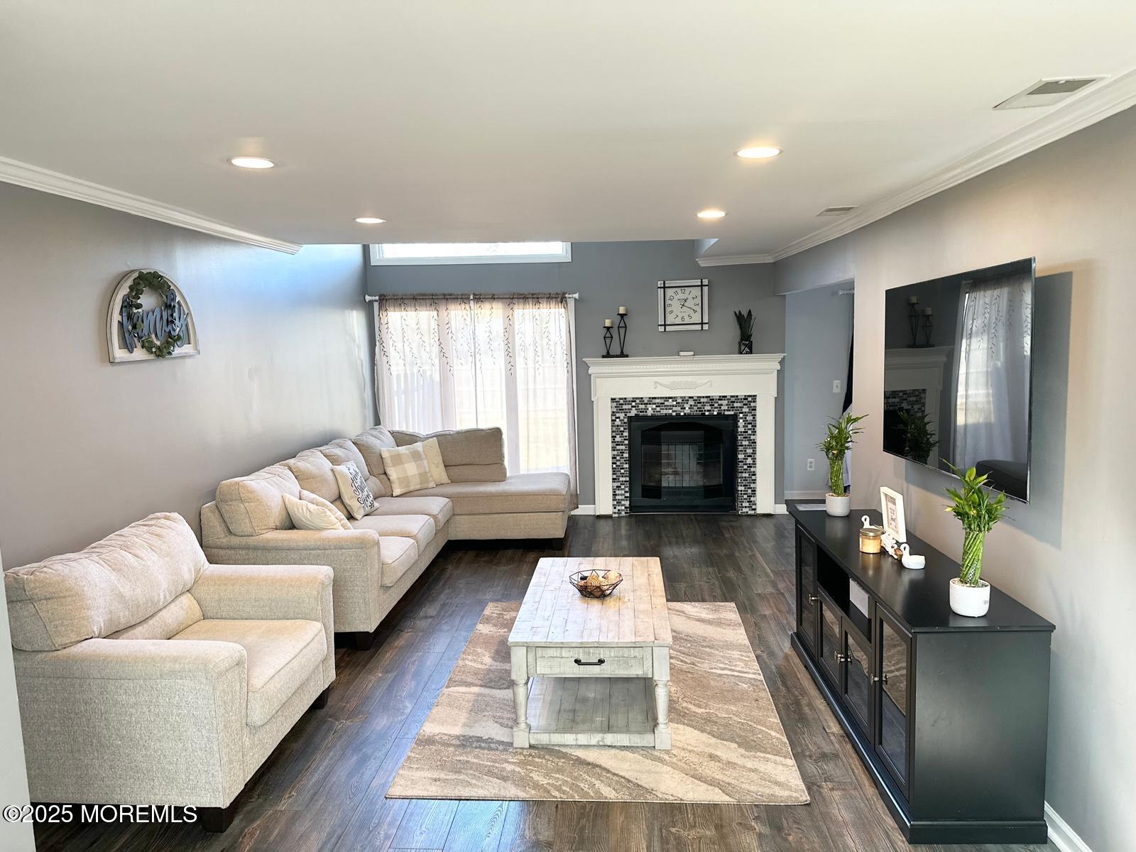 49 White Swan Way Brick, NJ 08723 - Photo 1 of 30 a living room with furniture and a fireplace