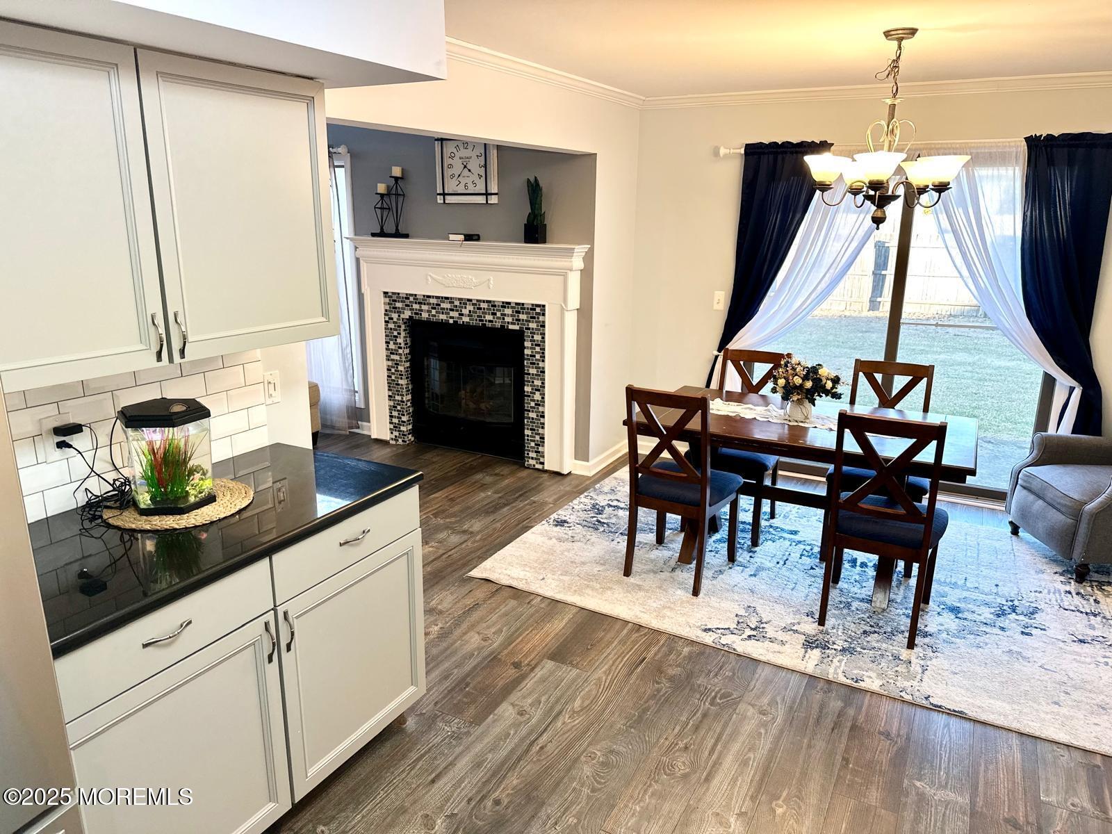 49 White Swan Way Brick, NJ 08723 - Photo 14 of 30 a living room with furniture a fireplace and a flat screen tv