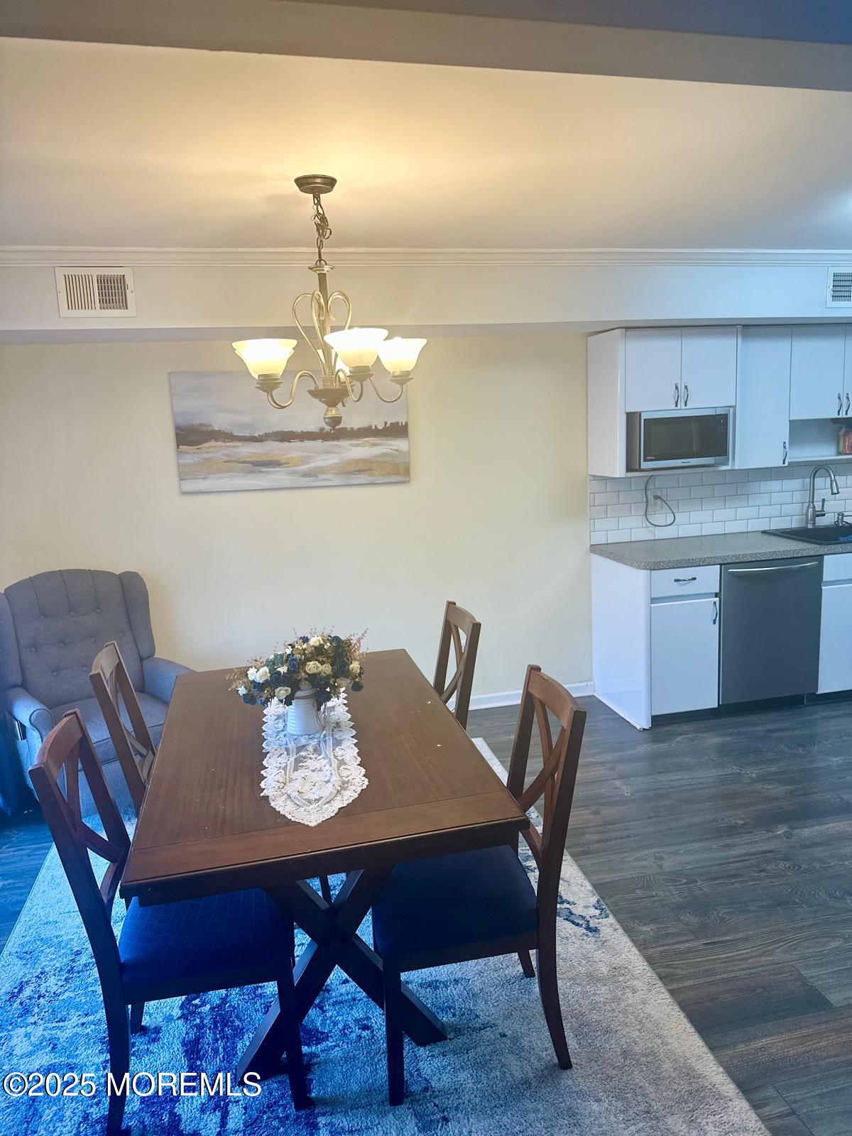 49 White Swan Way Brick, NJ 08723 - Photo 15 of 30 a view of a dining room with furniture and wooden floor