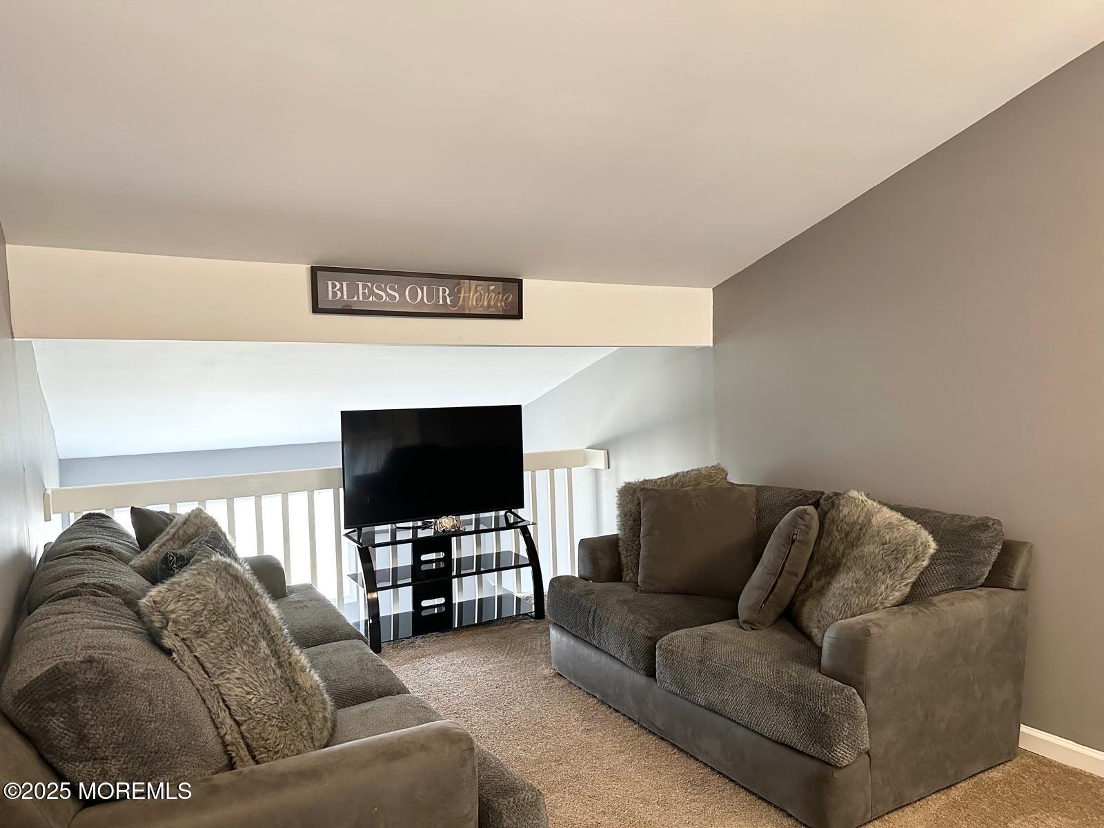 49 White Swan Way Brick, NJ 08723 - Photo 18 of 30 a living room with furniture and a flat screen tv