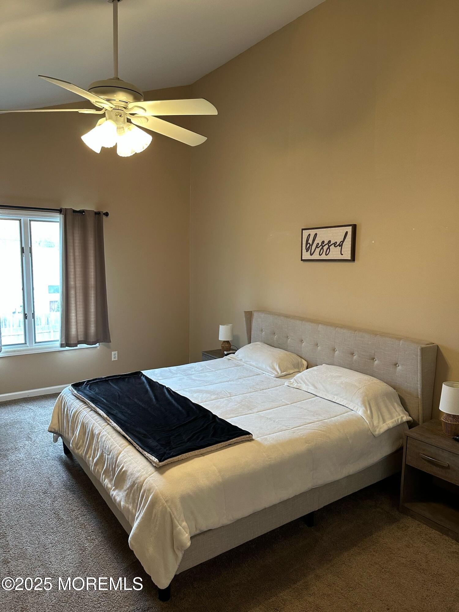 49 White Swan Way Brick, NJ 08723 - Photo 19 of 30 a bedroom with a bed and a chandelier