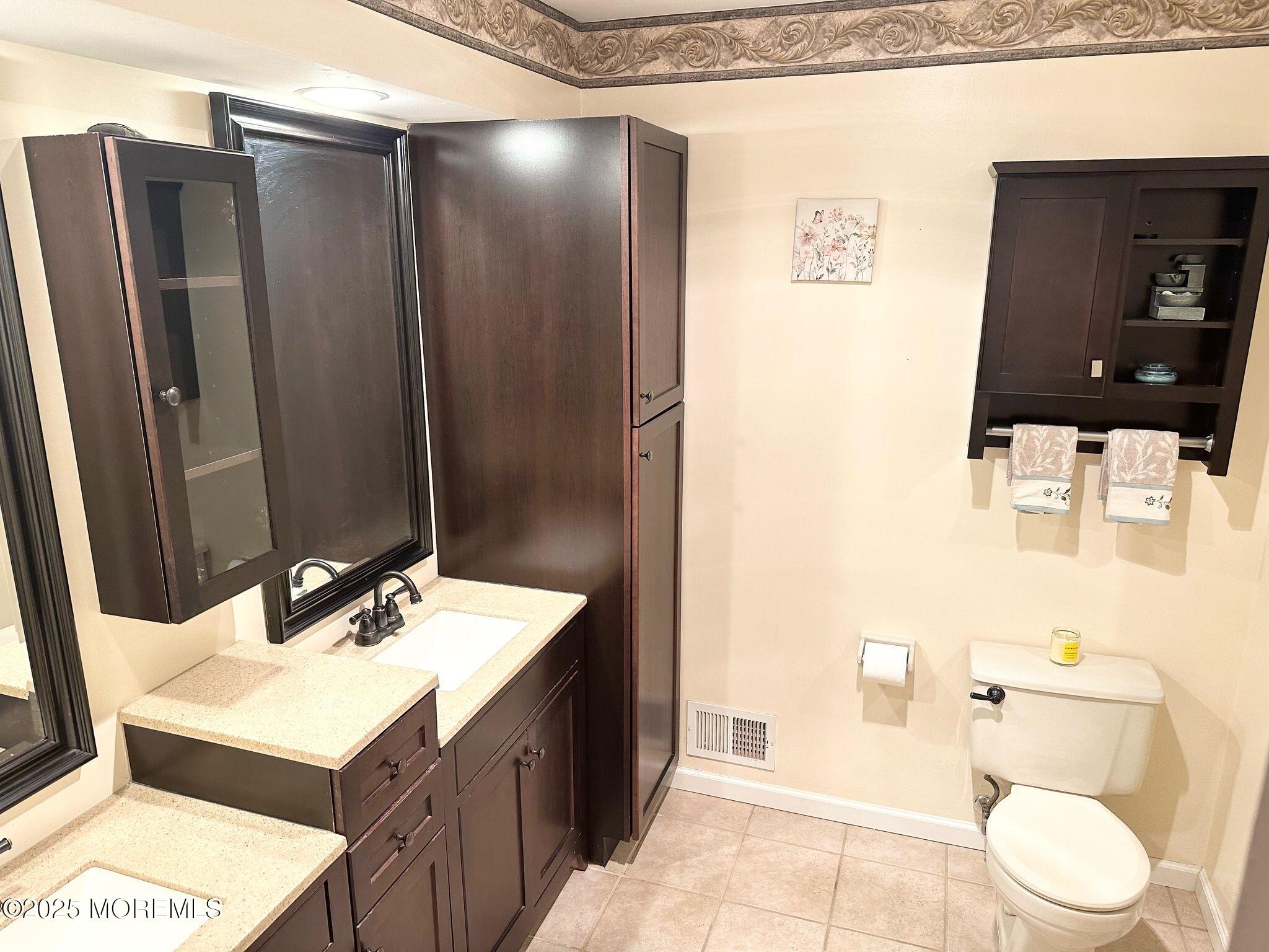 49 White Swan Way Brick, NJ 08723 - Photo 20 of 30 a bathroom with a sink a toilet and shower
