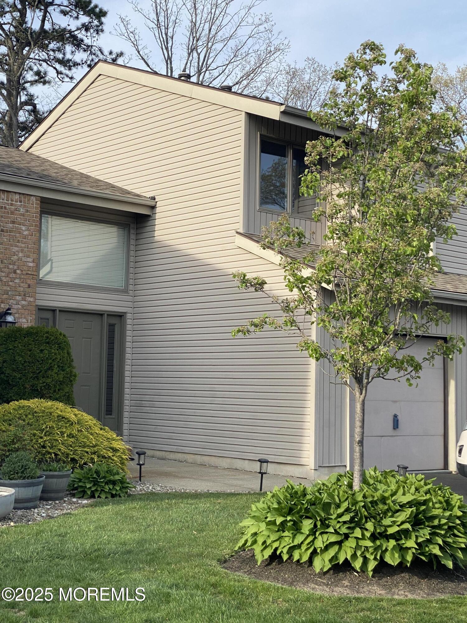 49 White Swan Way Brick, NJ 08723 - Photo 2 of 30 a front view of a house with a yard