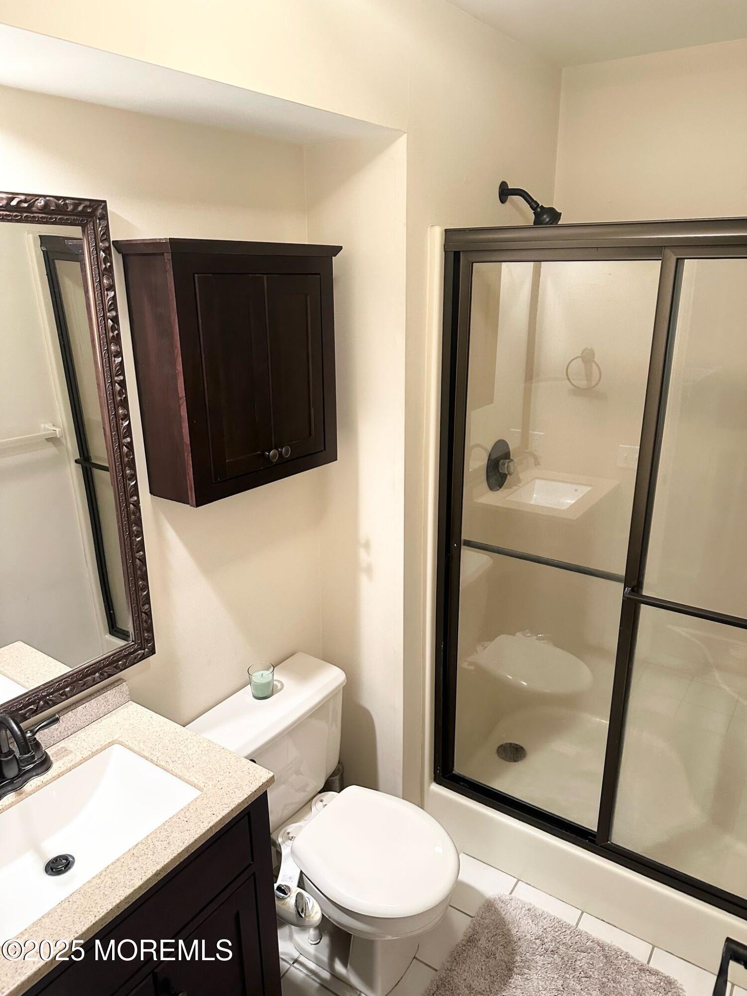 49 White Swan Way Brick, NJ 08723 - Photo 23 of 30 a bathroom with a sink a toilet a mirror and shower